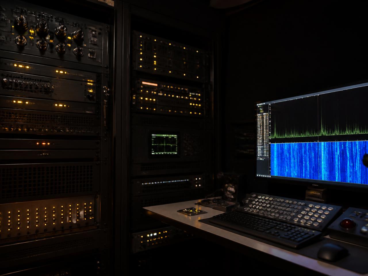 Signals intelligence equipment rack in a darkened control room